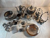 Group shot of all silver-tone serveware and décor items