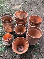 Front view showing stacked terracotta pots and saucers