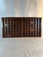 Front view of wooden type tray showing full compartment grid