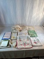 Overview of assorted embroidered linens laid on table