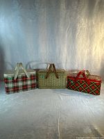 All three vintage metal picnic baskets side by side