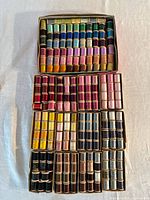 All boxes of thread spools laid out to show quantity and colour range