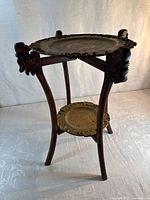 Full view of wooden side table with upper and lower brass trays