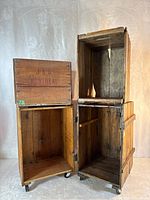 Two stacked open crates showing interior construction and casters