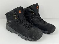 oblique view of both boots showing uppers, lacing, and overall condition