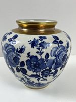 Full view of vase showing blue floral pattern and gold band