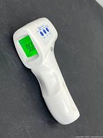 Thermometer front with LCD illuminated at 36.6°C