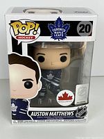 Front of boxed Funko Pop! Auston Matthews figure showing branding, exclusive sticker and product number 20