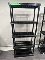 Front view of black plastic shelving showing five shelves
