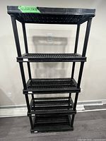 Front view of black plastic shelving unit with five shelves