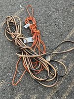 Both coiled extension cords on pavement