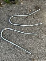 Both curved steel arms on ground