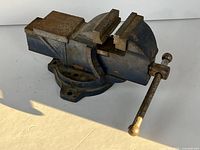 Overall view of cast-iron bench vise showing jaws, swivel base and handle
