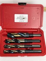 Open case showing four large drill bits
