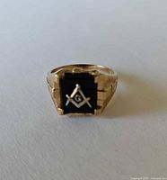 Front view showing black onyx face with Freemason insignia and gold band
