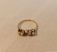 Top view of gold ring showing four set pearls