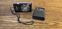 Front view of Canon PowerShot ELPH 160 camera and Canon battery charger
