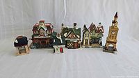 Group image of six ceramic Christmas village structures