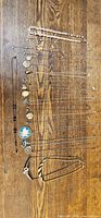 All sixteen necklaces laid out on wood surface