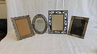 All four metal 5" x 7" frames standing side by side