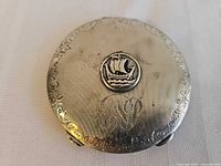 Top view showing Viking ship medallion, NP monogram, chased border