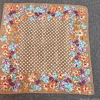 Full view of brown square scarf with polka dot center and floral border