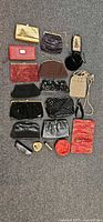 Full layout of sixteen vintage purses and accessories on carpet