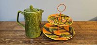 Coffee pot and tiered plate side by side
