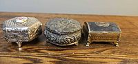 Three metal jewellery boxes side view