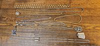 All necklaces laid out horizontally showing length, pendants and chain styles