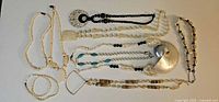 All eight shell and stone necklaces displayed
