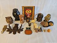 Group shot of entire owl collection showing variety of figurines, picture and purse