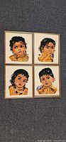 All four framed needlepoint portraits