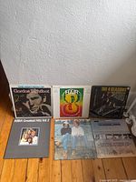 Group shot of all six vinyl records in lot