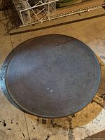 Front view of entire round brass wall art showing size and design