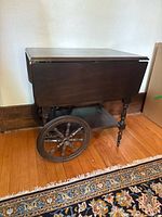 Full view of tea trolley with leaves down showing wheels and lower shelf