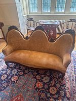 Full view of carved Victorian couch on rug