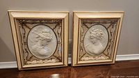 Both framed cameo plaques standing side by side