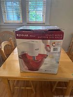 Front of sealed Jenn-Air Attrezzi stand mixer box showing product image with red glass bowl