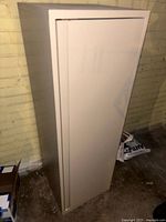 Front view of beige metal locker cabinet closed