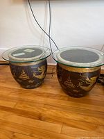 Both ceramic dragon pots with glass tops side by side