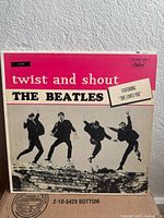 Front sleeve displaying title, artist, jumping Beatles image, Capitol logo