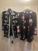Front view of both embroidered Nygard coats on hangers
