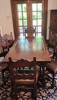 Dining table with six chairs around it