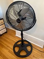 Full view of Whirlpool pedestal fan on floor
