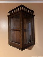 Cabinet mounted on wall, door closed showing overall form