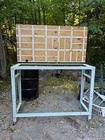 Full view of metal workbench with back panel outdoors