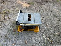 Full view of DeWalt portable table saw on ground