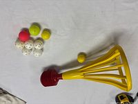 Popper with cluster of ten balls on white surface