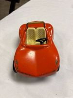 Front view showing orange body, seats, steering wheel